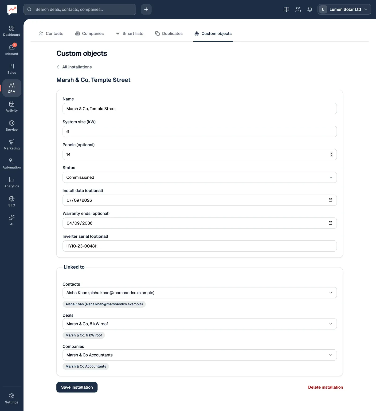 The Marsh & Co, Temple Street installation: System size (kW) 6, Panels 14, Status Commissioned, Install date 07/09/2026, Warranty ends 04/09/2036 and Inverter serial HY10-23-004811. Under Linked to are the contact Aisha Khan, the deal Marsh & Co, 6 kW roof and the company Marsh & Co Accountants, with Save installation and Delete installation at the bottom.