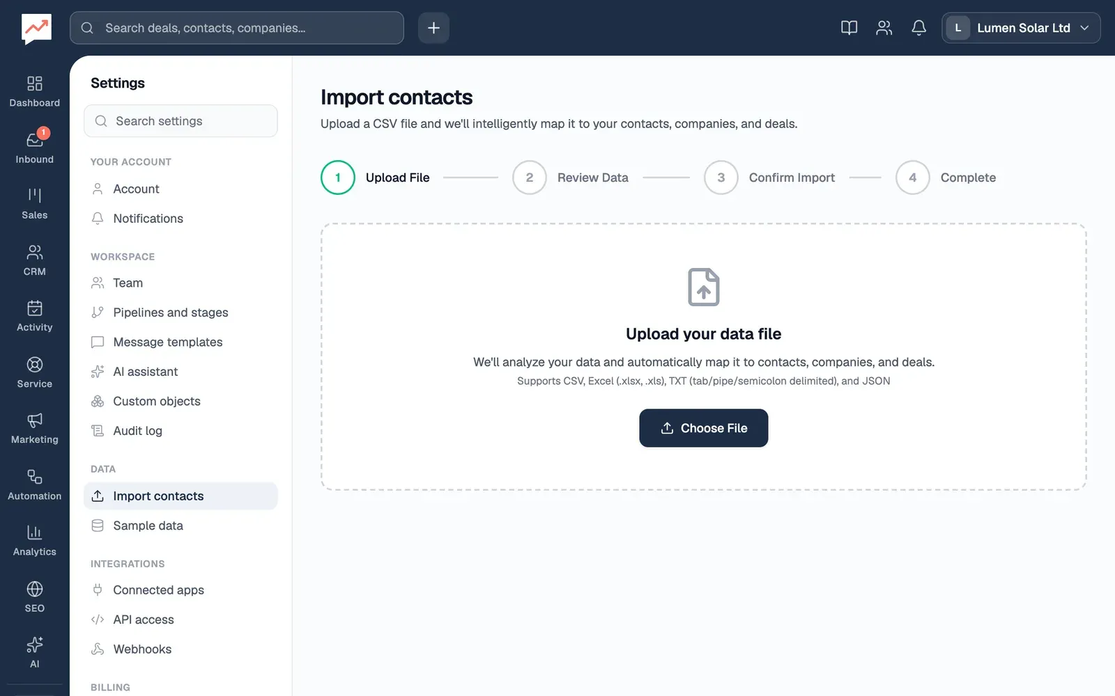 The Import contacts page at its first step, Upload File, with the steps Review Data, Confirm Import and Complete still to come, and a Choose File button for a CSV, Excel, TXT or JSON file.